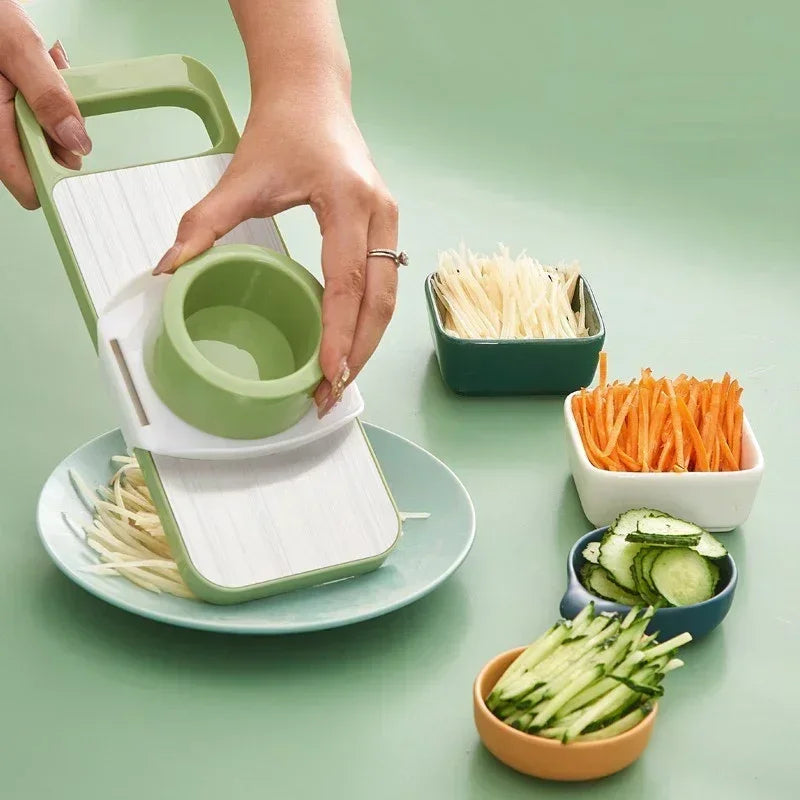FusionCharm 5-in-1 vegetable cutter kitchen set with stainless steel blades, including slicer and chopper tools, displayed on a countertop.